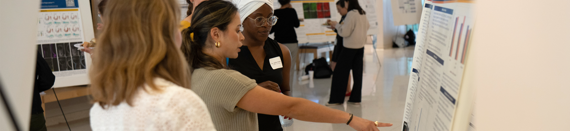 Researchers looking at a poster presentation.